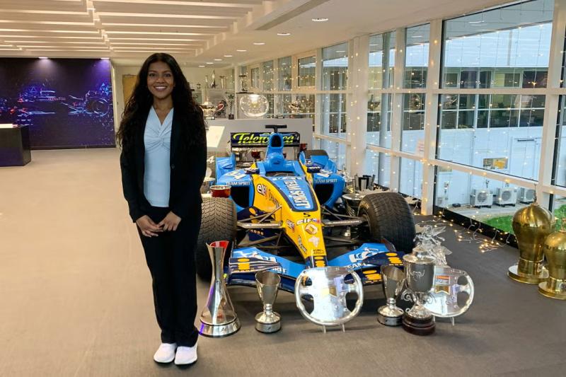 Aarabhi Krishnakumar beside a Formula One racecar during her Alpine internship.