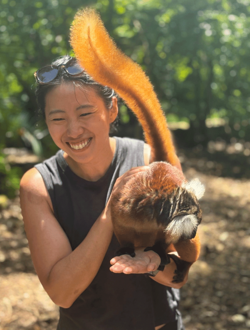 Kristen Tsai holds a lemur in Nosy Be, Madagascar.